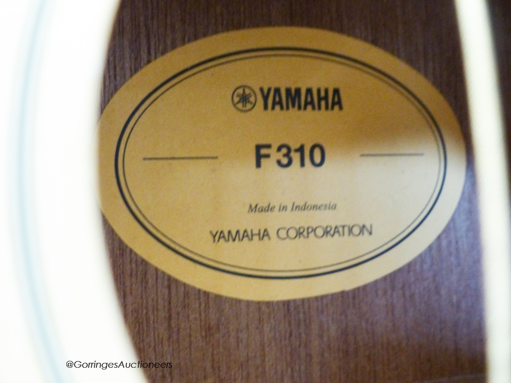 A Yamaha F310 acoustic guitar, carry case